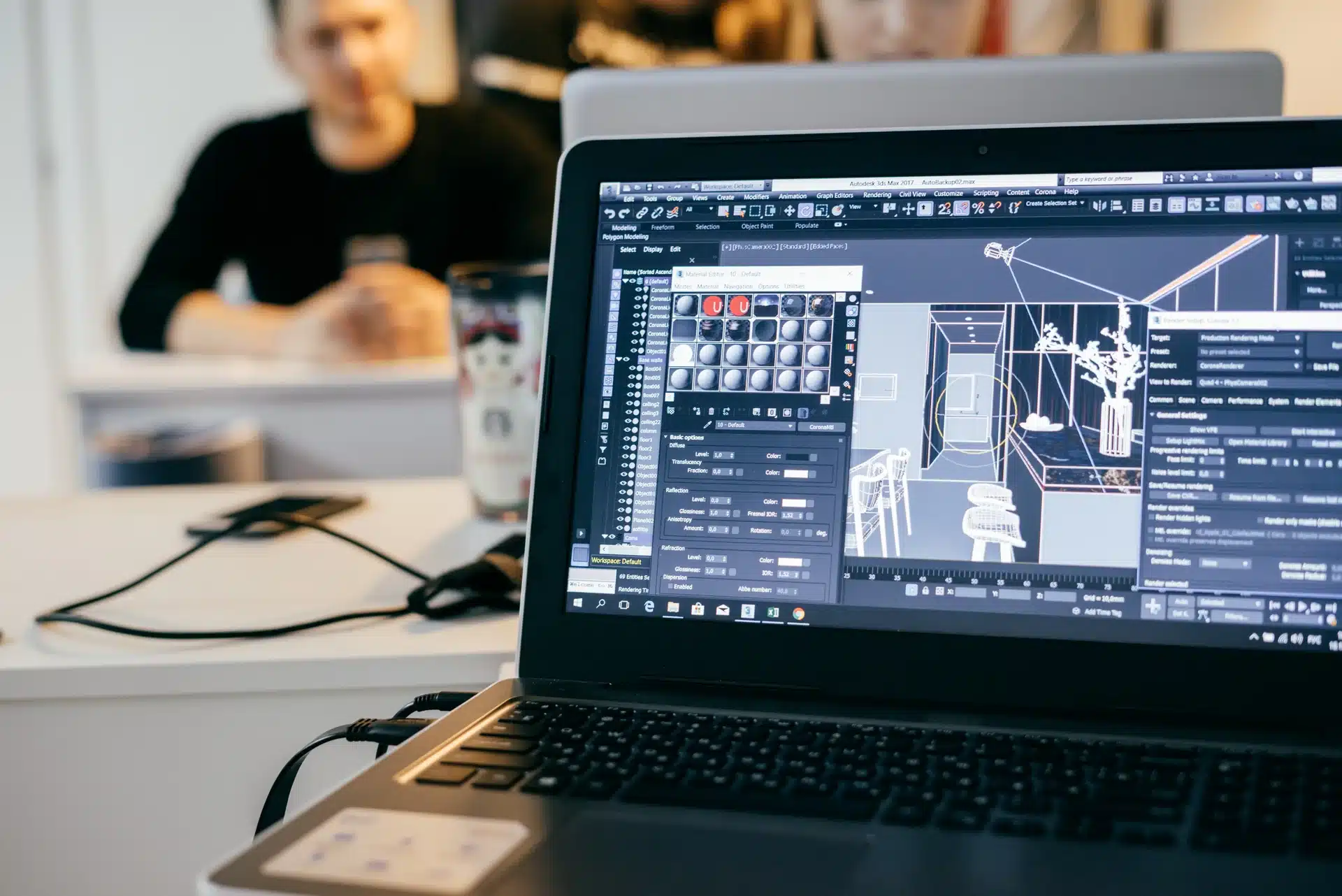 Designer creating detailed 3D rendering of an interior design project on a workstation with architectural models and material previews on screen.