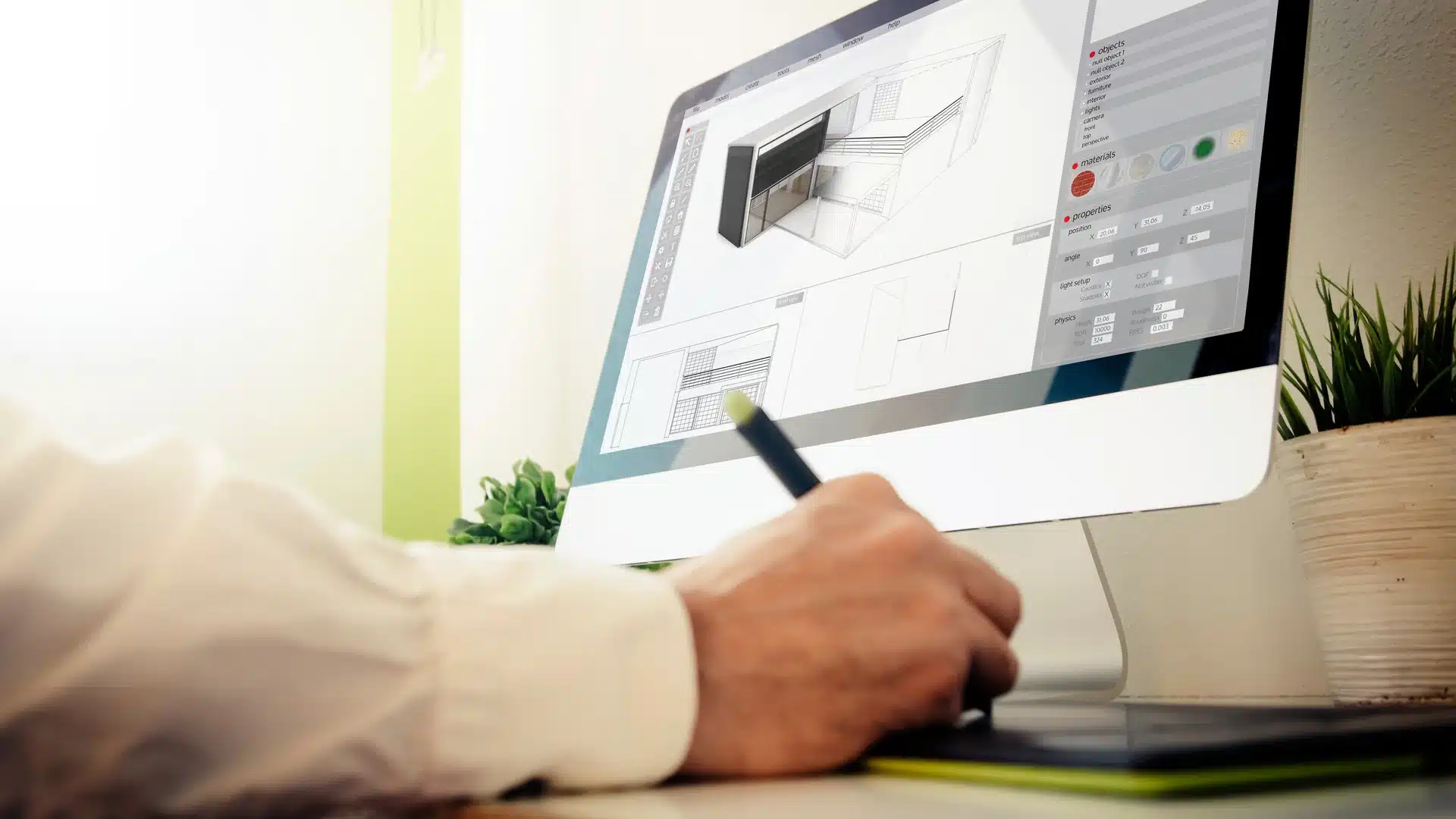 Designer working on a computer setup, creating 3D visualisation, rendering, and animation for an architectural project with detailed digital models on screen.